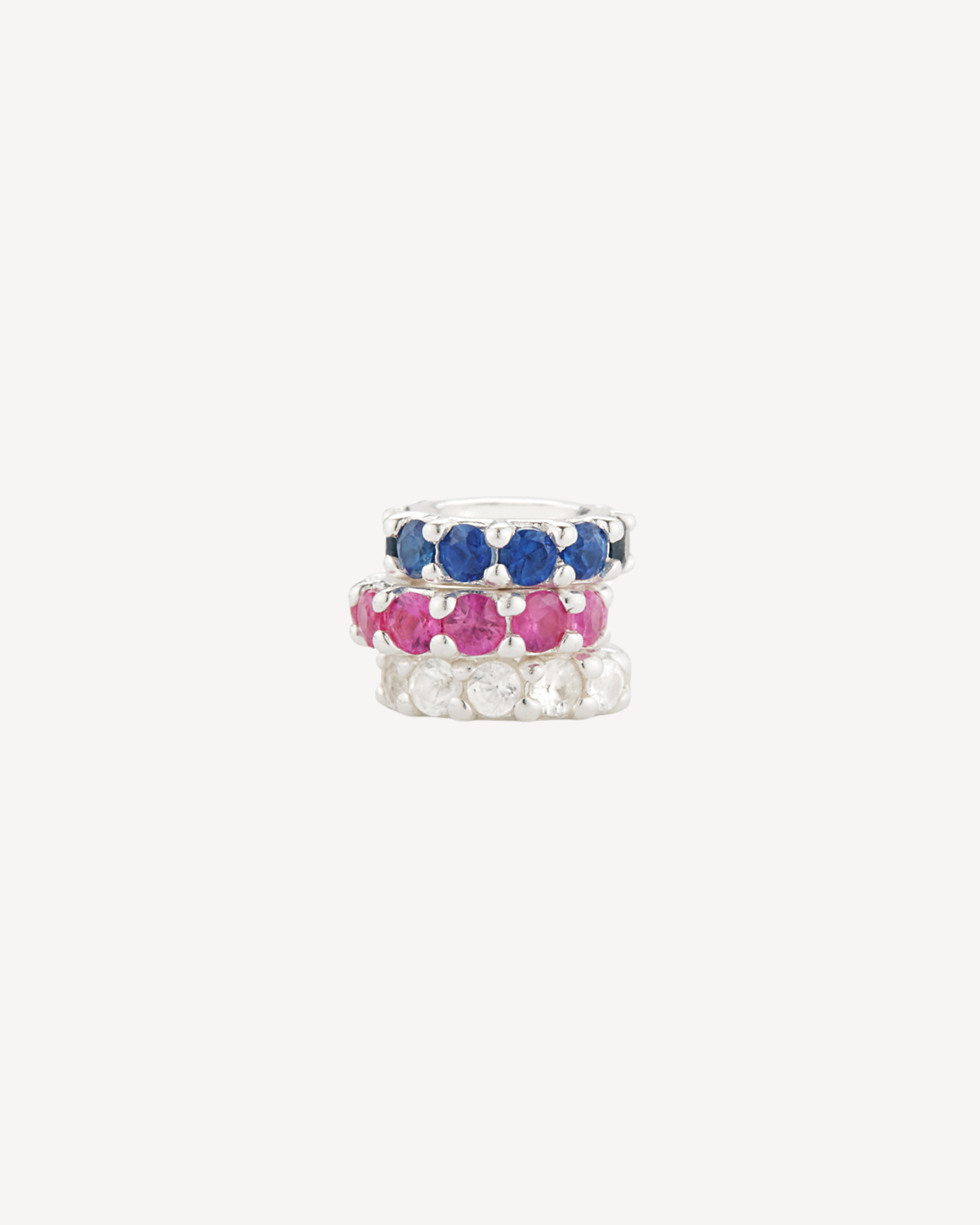 a stack of red, white, and blue jewelry. ruby halo, sapphire halo, and diamond halo. halos to add onto any necklace. made by love billy.