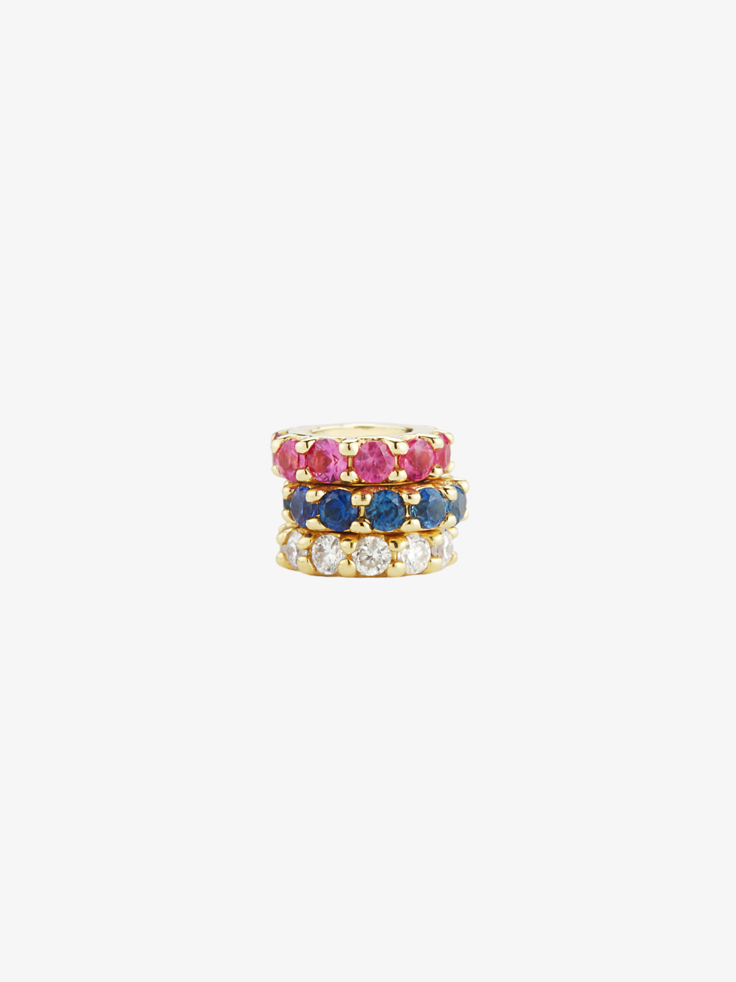 a stack of red, white, and blue jewelry. ruby halo, sapphire halo, and diamond halo.