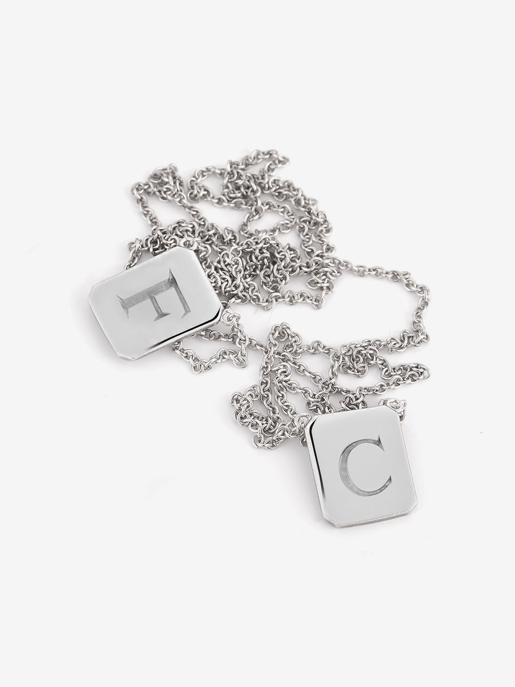 Personalized Love Billy silver tag necklace. one with the letter F, the other with the Letter C.