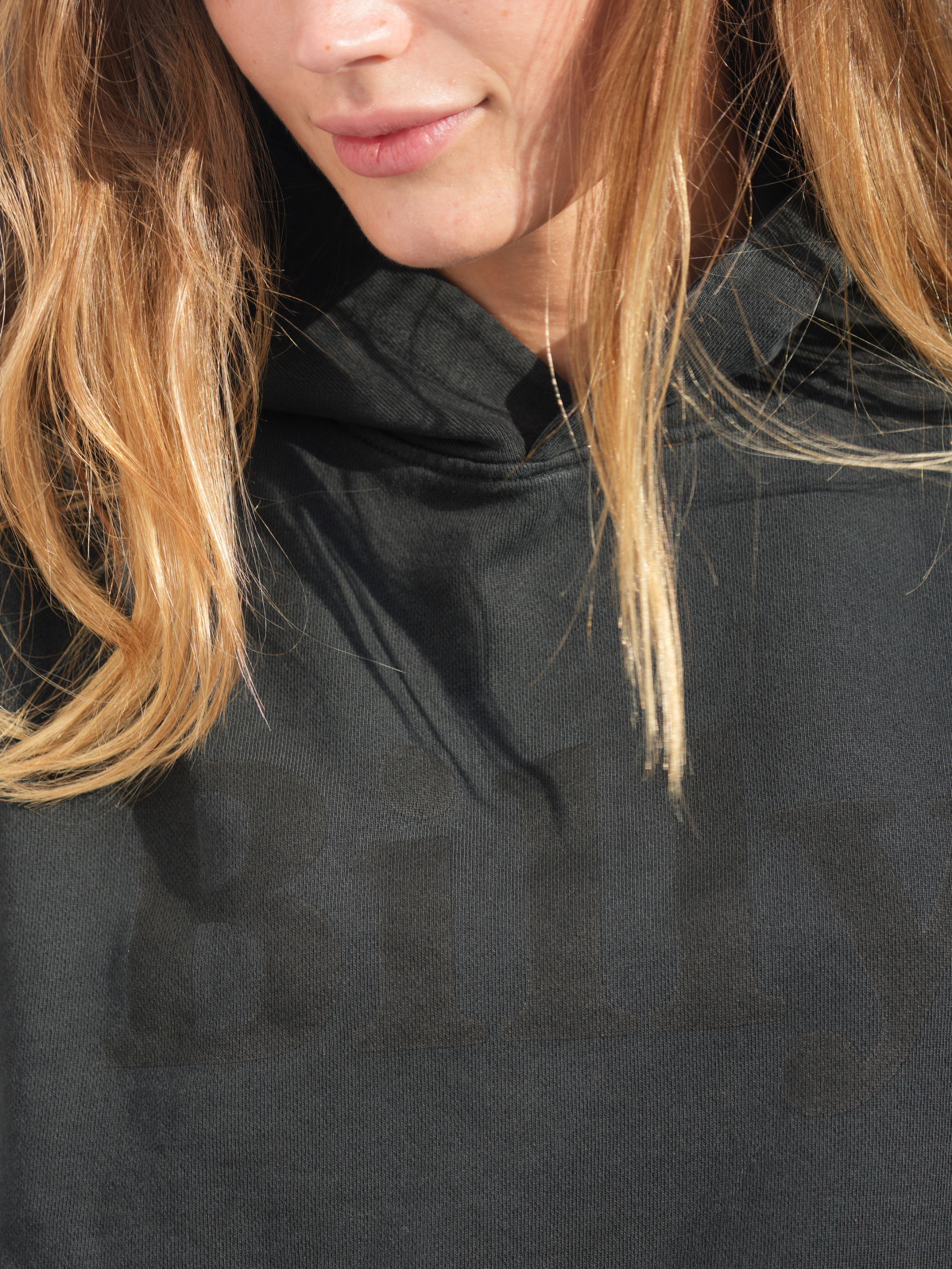 young girl wearing black on black hoodie by love billy.