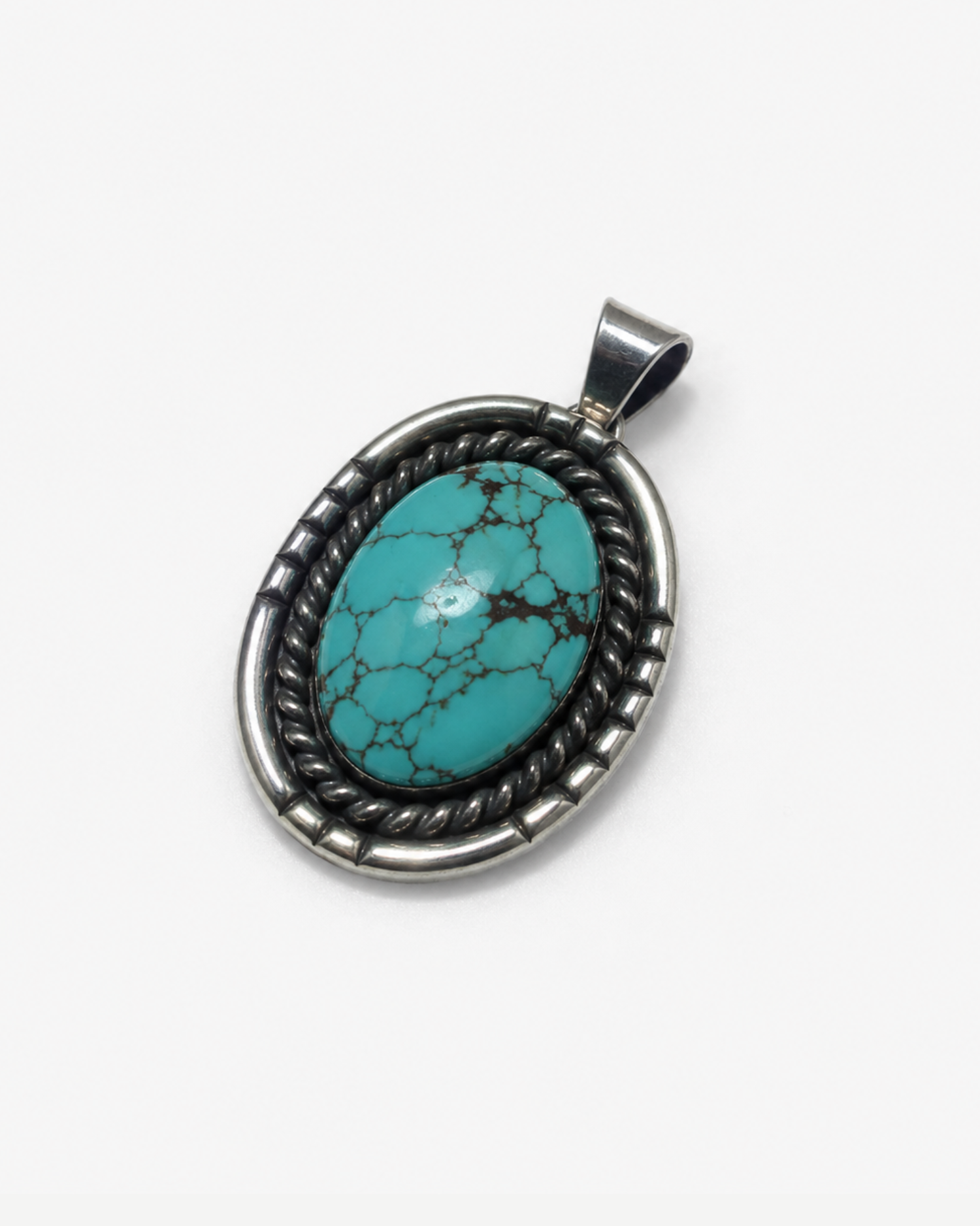 An oval turquoise pendant with a dark, oxidized silver-toned twisted border and bail, shown on a plain light gray background.