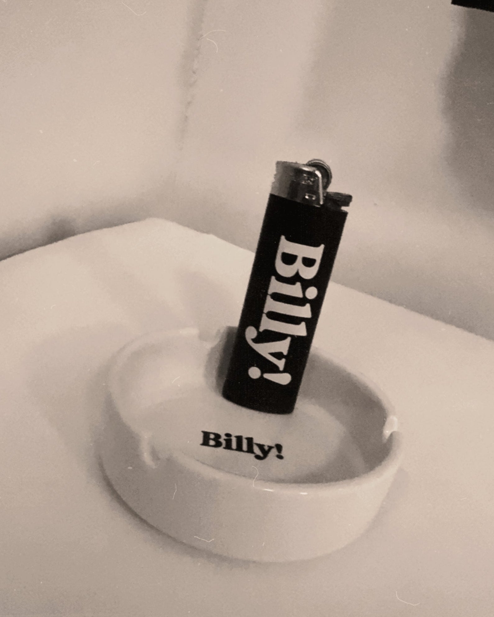black bic lighter and cermaic ashtray both with billy! logo