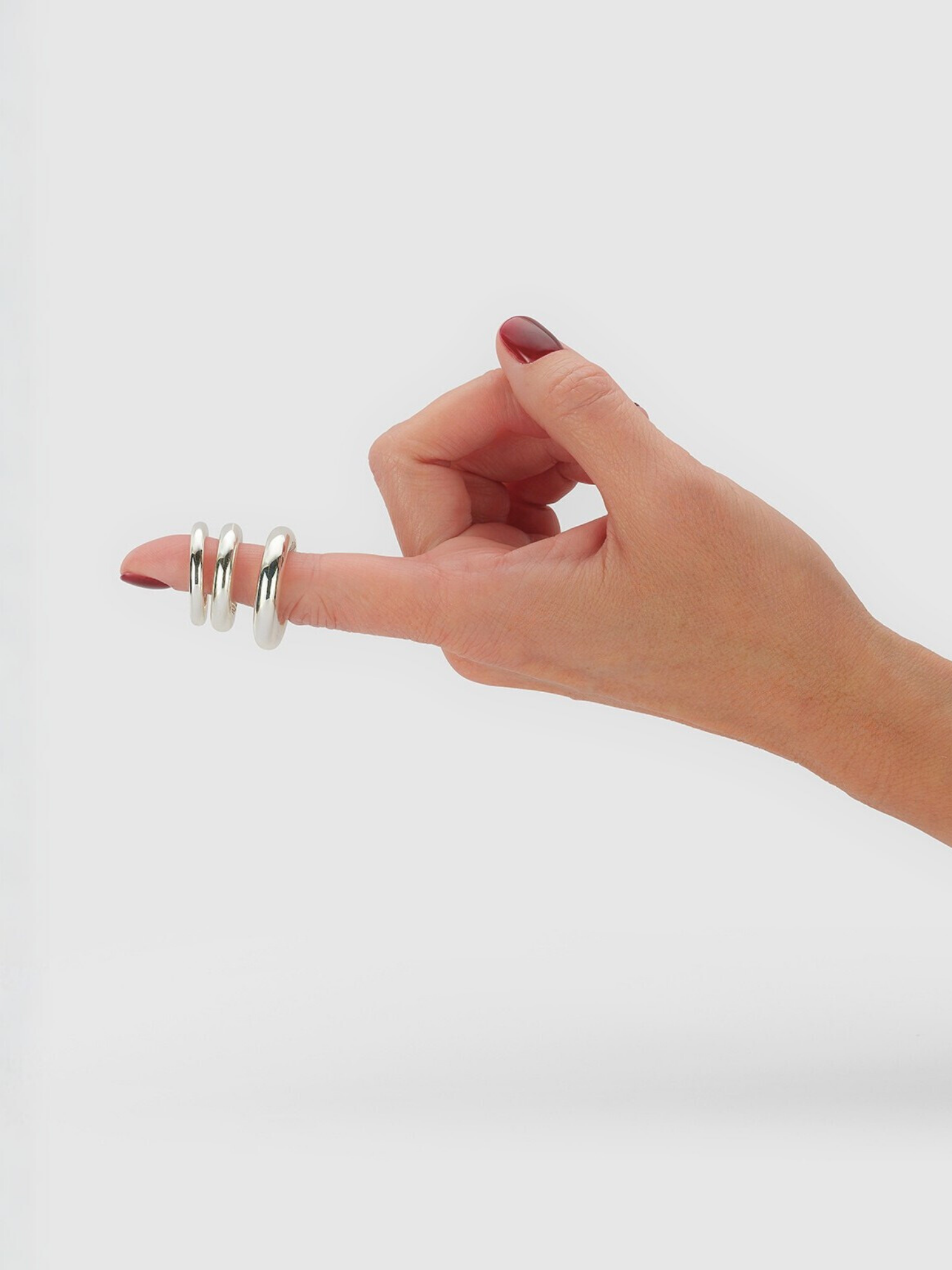 hand with finger pointing showing the mini, regular, and jumbo carousel rings