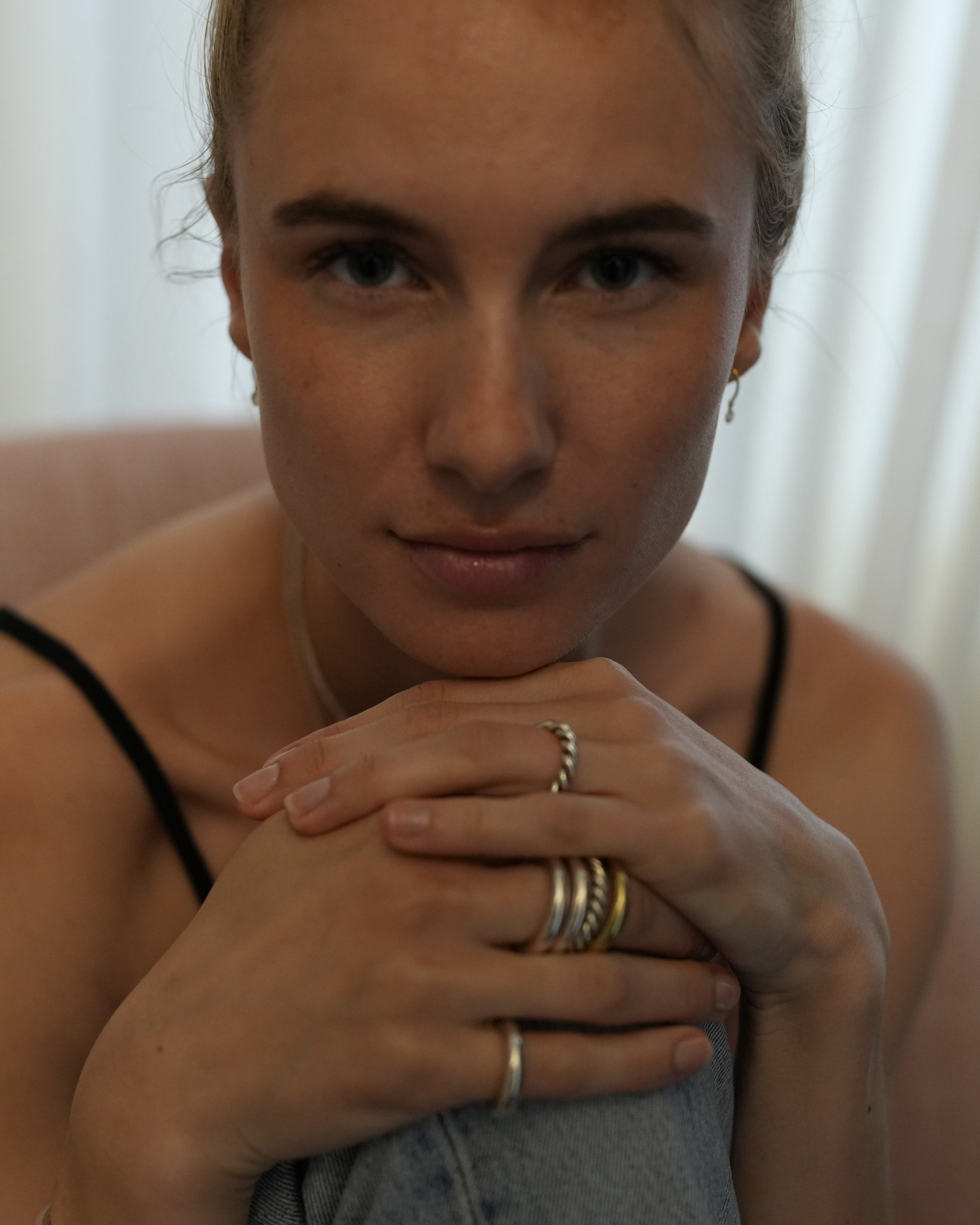 women sitting with knees up with stacks of love billy carousel rings