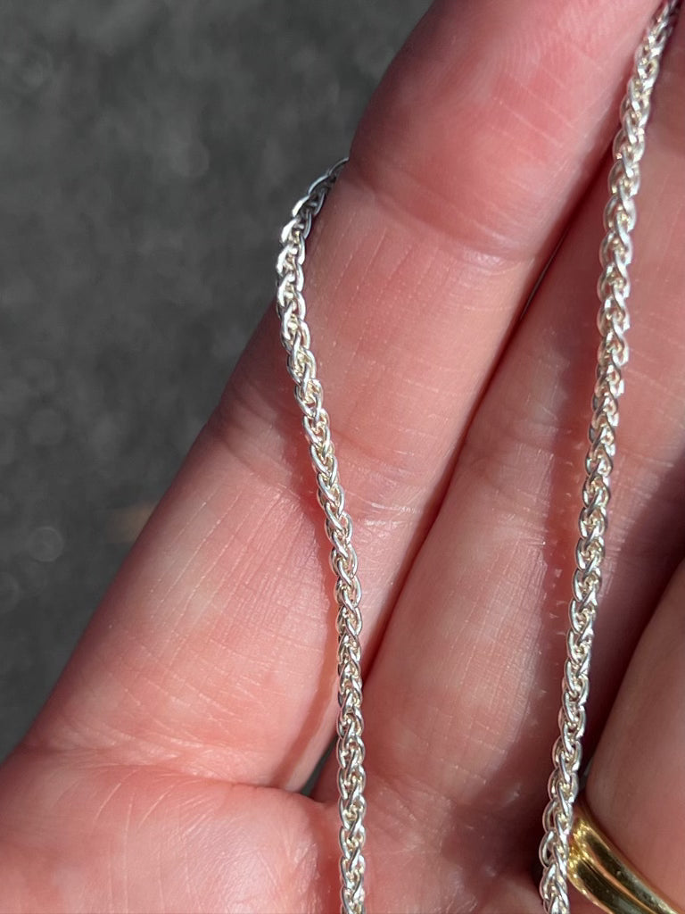 love billy silver wheat chain being held.