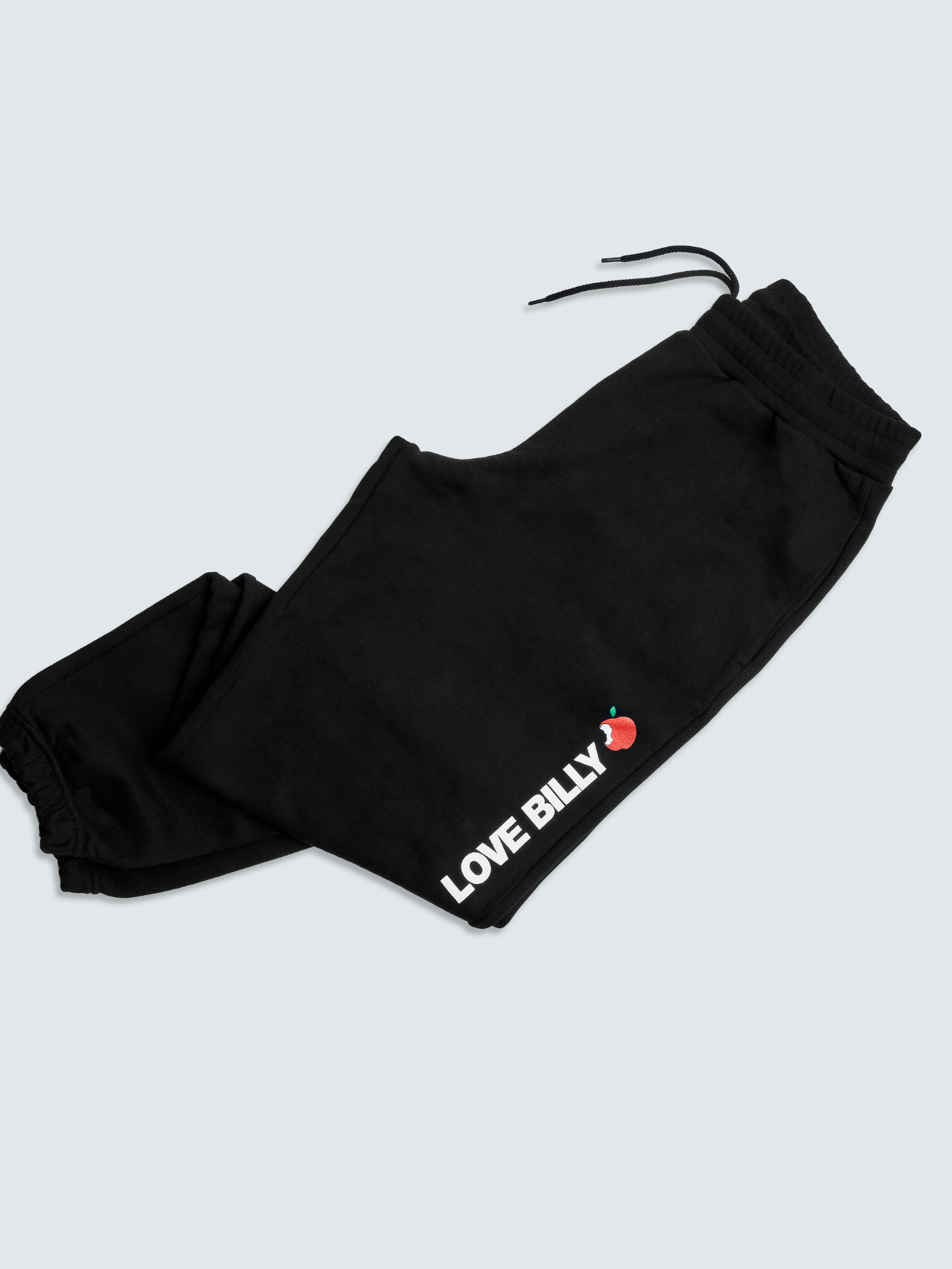 black NYC sweatpants by love billy slightly folded in the bottom half.
