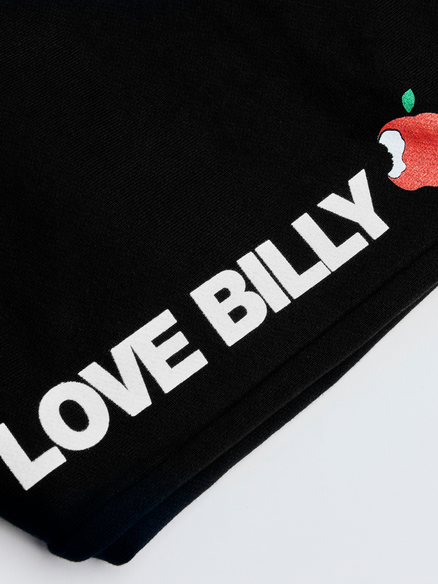 Closeup of the love billy logo on the black NYC sweatpants by love billy.