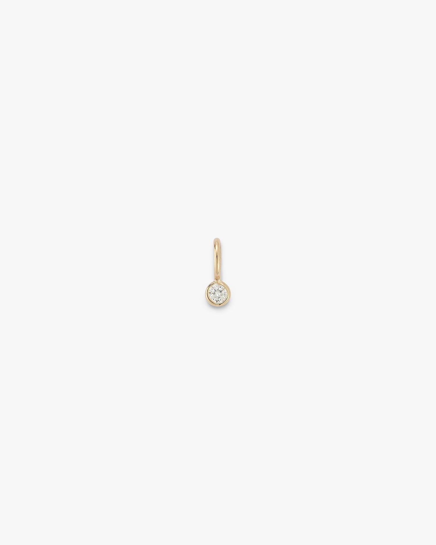 Gold gemstone drop with a diamond on a white background