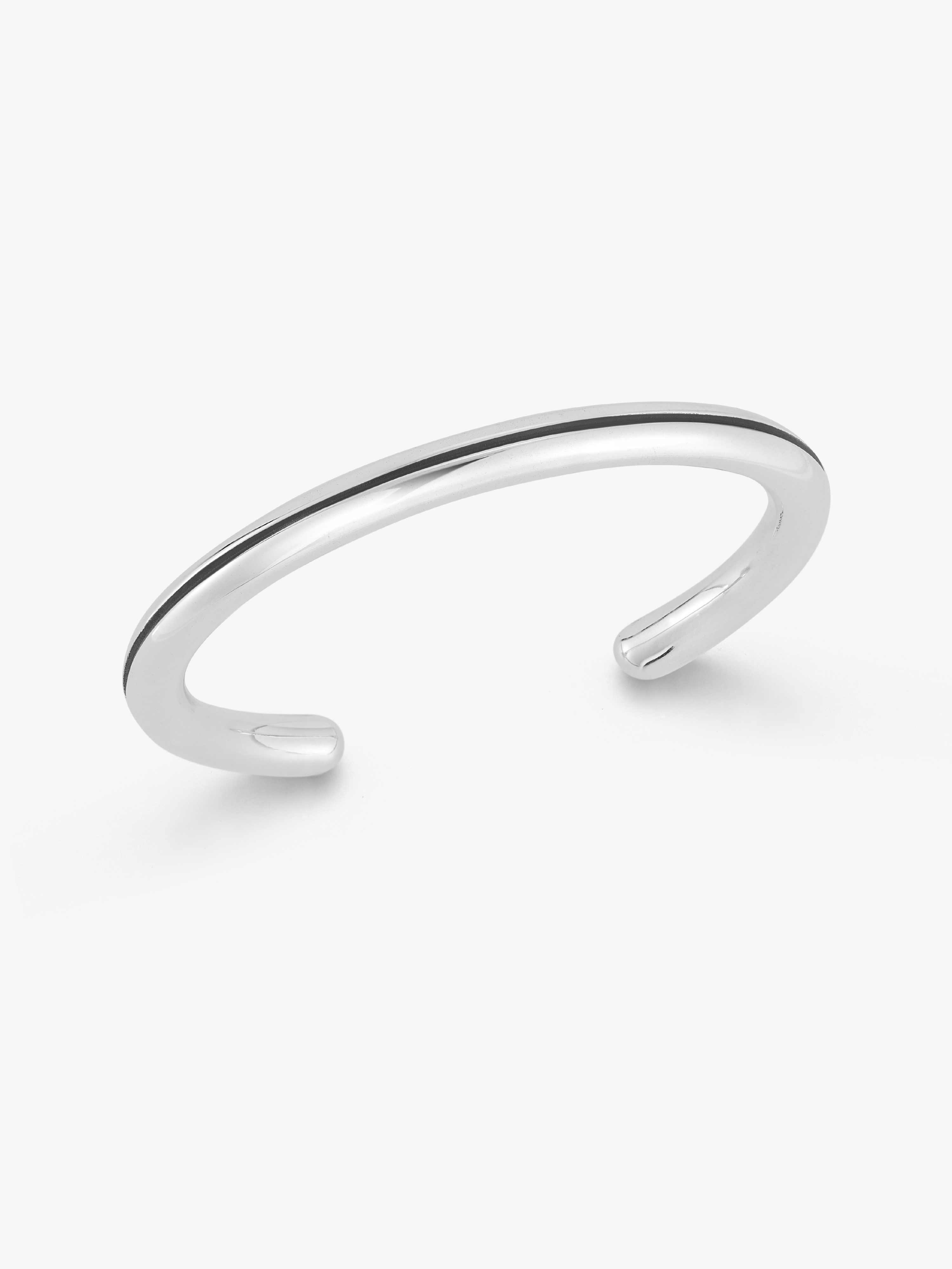A minimalist polished silver cuff bracelet with a smooth, open-ended design, photographed on a clean white background. A silver notch in middle.