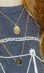 Girl wearing washed nantucket crewneck with two Gold necklaces. One is the gold stars medallion and the other is the letter 'F' tag medallion. Crewneck and necklaces made by Love Billy in NYC. 