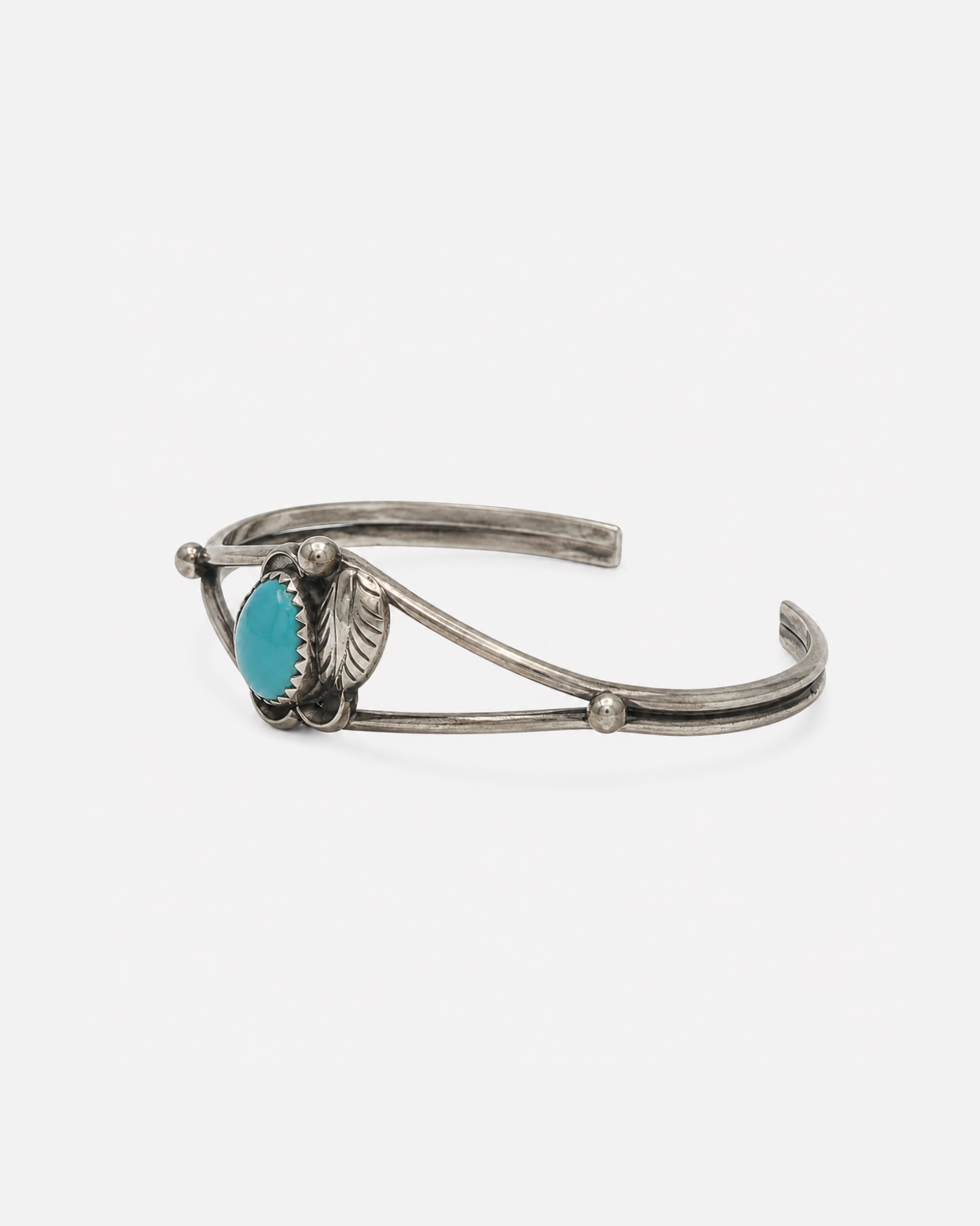 Sterling Silver Cuff with a turquoise stone surrounded by a silver flower and petal design. Vintage wear.