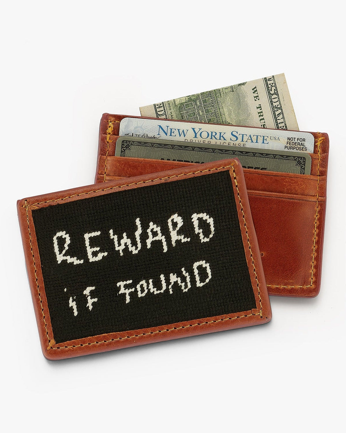 A Smathers & Branson custom engraved wallet reading "Reward if Found". Stitched by hand, vegetable dyed leather, 3 card slots and one center slot. Black engraving with white writing on brown leather. Love Billy. 