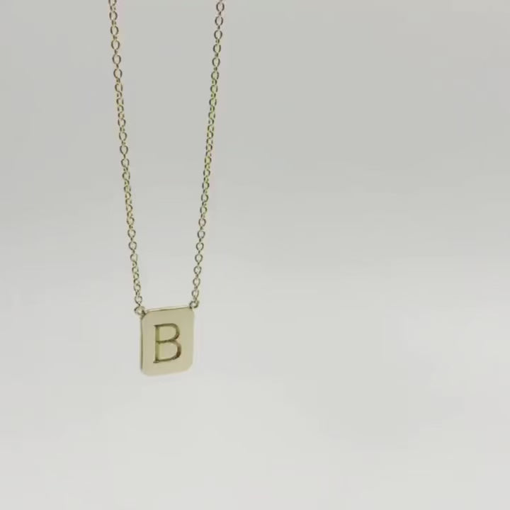 movie of gold tag necklace dropping though the screen