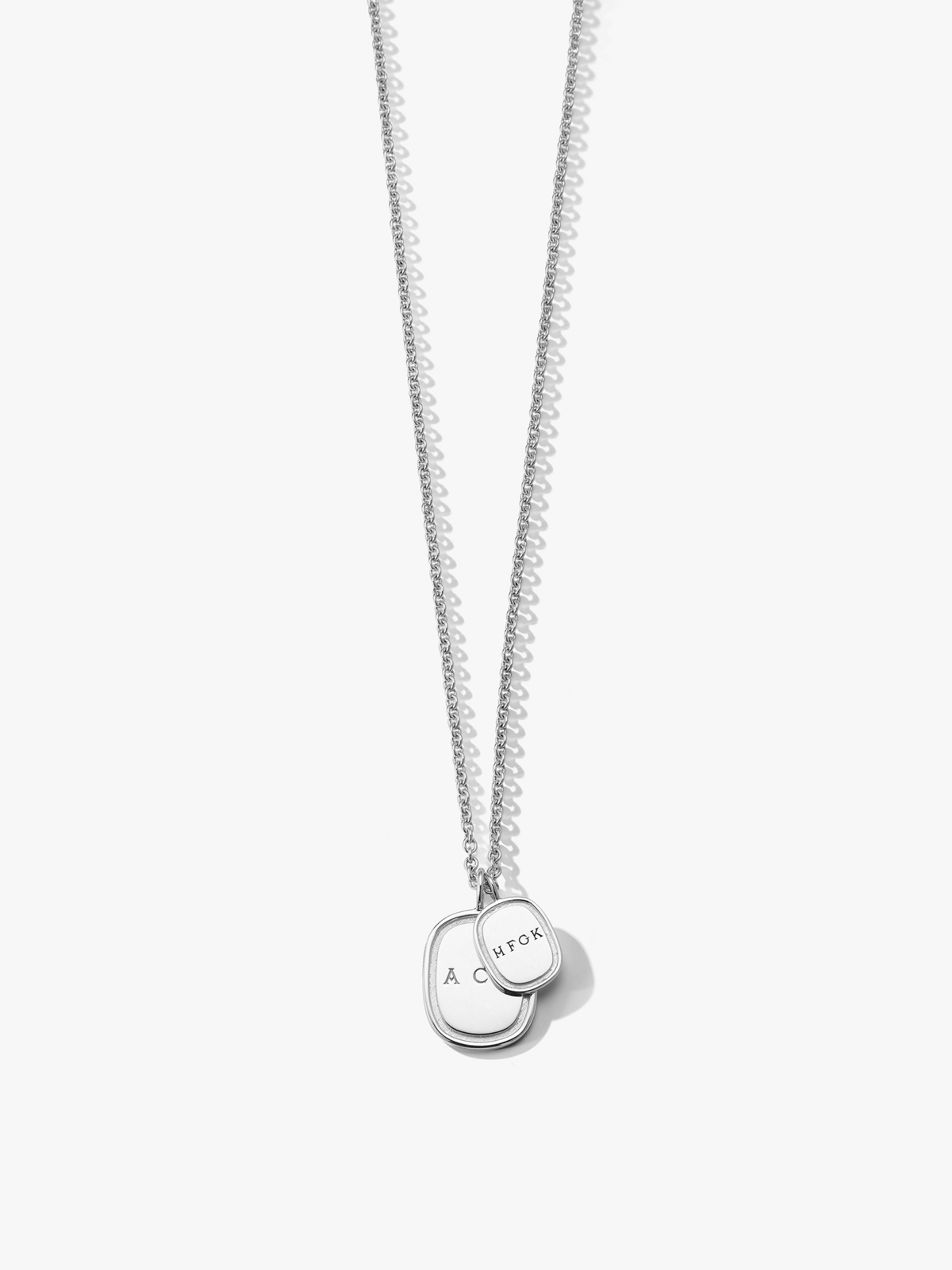 A silver oblong pendent necklace. One larger pendent with a smaller pendant layered on top. Both engraved with initials. Love Billy made in NYC. 
