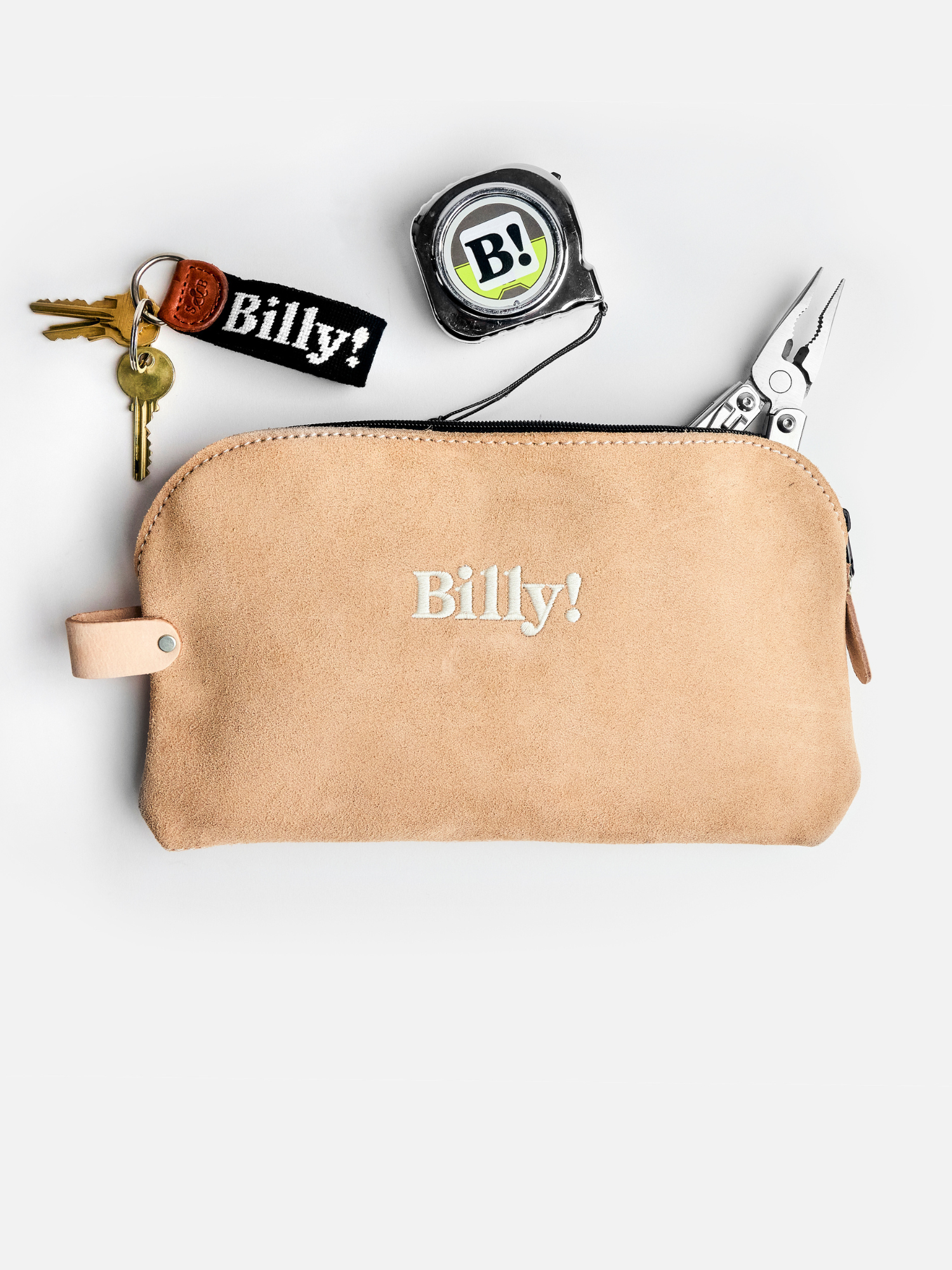 beige love billy suede pouch with Billy! embroidered in the middle. Keychain, pliers and a tape measure coming out the pouch.